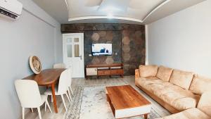 a living room with a couch and a table at 3 bedhroom(200 square meters) near the beach in Lara