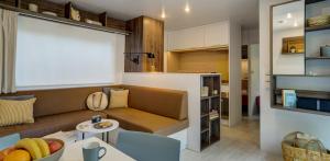 a living room with a couch and a table at Mobile Homes by KelAir at Camping La Sirene in Argelès-sur-Mer