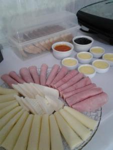 a tray of different types of cheese and other foods at Pousada Renascer in Serra do Cipo