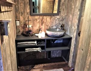 a bathroom with a sink and a counter with a mirror at GIFFORD private Island GLAMPING boat ride included in Mahone Bay