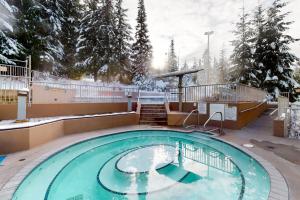 a large swimming pool with snow on the ground at Woodrun #418 in Whistler