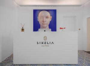 a wall with a picture of a man on it at Sikelia Suites in Noto
