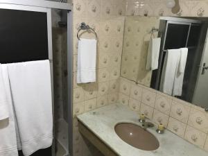 a bathroom with a sink and a mirror and towels at MIX APART Hotel in Brasília