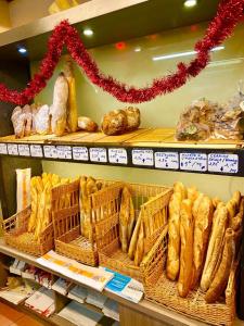 a bakery with lots of bread in baskets on a shelf at Les Arcades in Villecroze