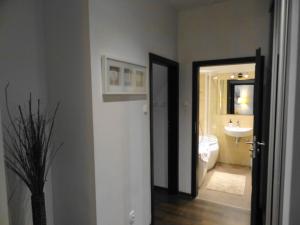 uma casa de banho com um lavatório, um WC e um espelho. em Apartamenty Arkadia by VisitWarsaw Apartments em Varsóvia