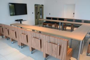 a classroom with tables and chairs and a flat screen tv at Live Hotels Bordeaux Lac in Bordeaux