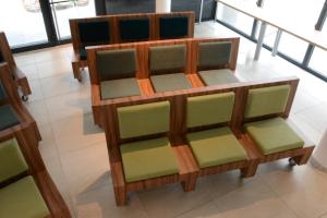 a wooden shelf with green seats in a room at Live Hotels Bordeaux Lac in Bordeaux