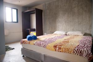 a bedroom with a large bed with blue pillows on it at 9 Hostel in Chiang Mai