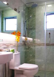 a bathroom with a shower and a toilet and a sink at Tai Ichi Hotel Kuala Lumpur in Kuala Lumpur