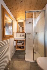 a bathroom with a shower and a sink at Hotel Slalom in Bettmeralp