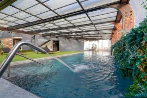 a pool with a water slide in a building at Well Hotel & Spa in Maceira