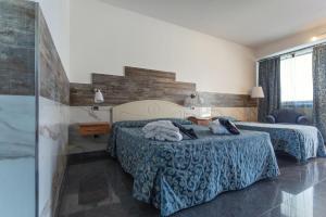 Postel nebo postele na pokoji v ubytování Hotel San Luca