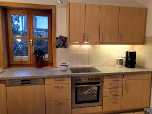 a kitchen with a sink and a stove top oven at Ferienhaus Erika in Garmisch-Partenkirchen +27 photos