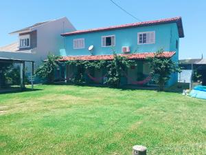 a house with a yard in front of it at Residencial Segundo Piso in Garopaba
