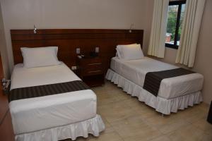 En eller flere senger på et rom på Posada del Cielo