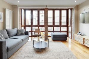 a living room with a couch and a table at Pamplonapartments Duque de Ahumada in Pamplona