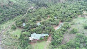 an aerial view of a house in the middle of a forest at Heysbrook Estate - Luxurious lodges in a private valley in Waterval-Onder