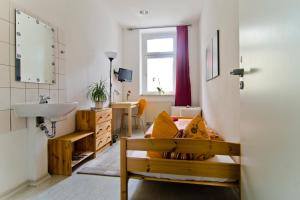 a bathroom with a bench and a sink in a room at Pension Piano Forte Leipzig Mitte in Leipzig +19 photos