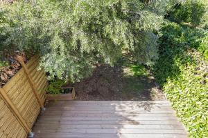 una vista aérea de una pasarela de madera bajo un árbol en Maison La Fontonne - Welkeys, en Antibes 10 fotos más