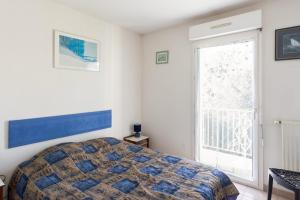 una camera con un letto e una grande finestra di Calm and sunny AC house with terrace and garden in Antibes - Welkeys a Antibes