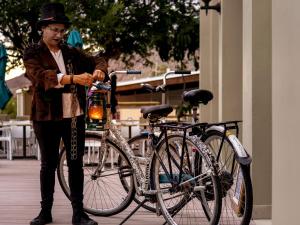 a man is standing next to a bike at Westway Corner in Montagu