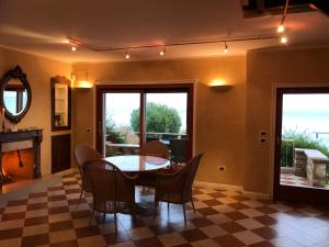 a dining room with a table and chairs at Lake Front Apartment - Direct Lake Access in Sirmione +115 photos