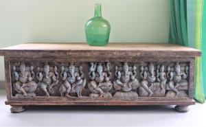 a wooden table with a glass bottle on top at The Spice House Mirissa in Mirissa