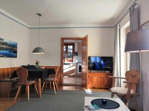 a living room with a table and a dining room at Ferienhaus Erika in Garmisch-Partenkirchen