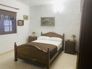 a bedroom with a large bed and two night stands at Casas Rita in Frontera