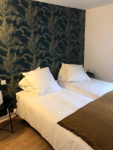 dwa łóżka siedzące obok siebie w pokoju w obiekcie Le Gîte du Jard w Épernay