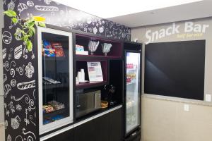 a snack bar with a black and white wall at Master Express Moinhos de Vento in Porto Alegre