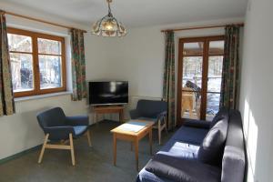 a living room with a couch and chairs and a tv at Haflingerhof Galster in Markt Taschendorf