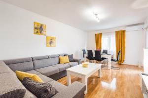a living room with a couch and a table at Apartman Angie in the centre of Metkovic in Metković