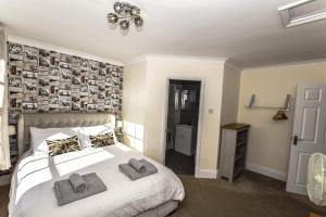 a bedroom with a bed with two towels on it at Greystones in Nottingham