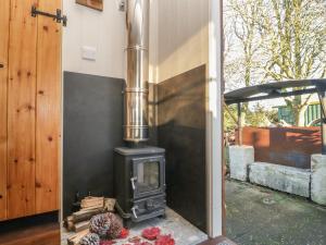 a wood stove sitting in a patio with at Keets at Middle Acre in Dorchester