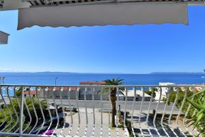 a view of the ocean from the balcony of a hotel at Villa Nora in Tučepi