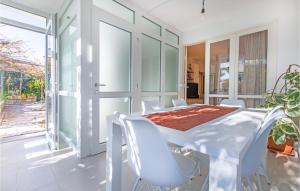 a white dining room with a white table and chairs at 1 Bedroom Nice Apartment In Lucija in Lucija