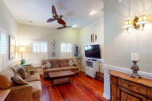 a living room with a couch and a flat screen tv at 1 Francis in Charleston