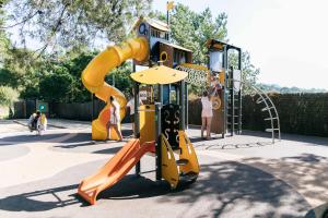 a playground with a slide in a park at Camping Tucan - Mobile Homes by Lifestyle Holidays in Lloret de Mar