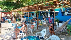 a group of people sitting in chairs on the beach at Monkey beach agroturismo in Gamboa