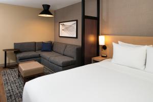 a hotel room with a bed and a couch at Hyatt Place Chicago Wicker Park in Chicago