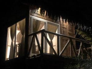 una finestra di una casa con tende di Cabalonga EcoAdventure a Puerto Cayo