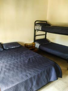 a room with two bunk beds in a room at Residencial Julia in Mar de Ajó