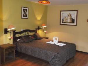 Postel nebo postele na pokoji v ubytování La Posada del Conde Lodge