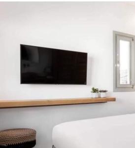 a flat screen tv on a wall in a living room at MarKaMar in Loutraki