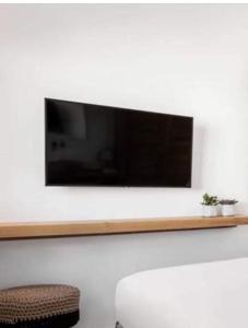 a flat screen tv hanging on a white wall at MarKaMar in Loutraki