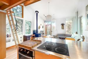 a kitchen with a stove top oven in a room at Coleman Creek House in Tillamook