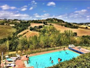 un grupo de personas en una gran piscina en Country House Montesoffio en Barchi