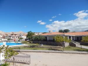 a villa with a swimming pool and a house at Hostería Municipal de Angastaco in Angastaco