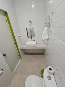 a bathroom with a toilet, sink, and bathtub at Casa Mia in Puerto Escondido
